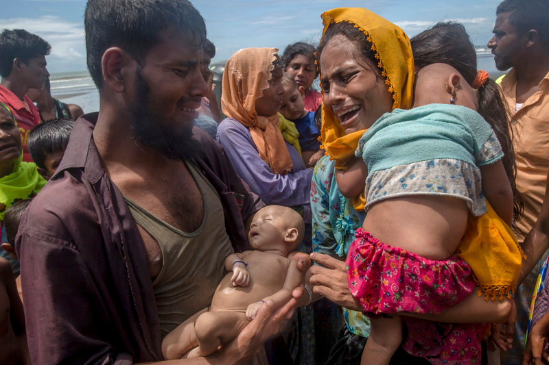 In this Sept. 14, 2017, file photo, Rohingya Muslim man Naseer Ud Din holds his infant son Abdul Masood, who drowned when the boat they were traveling in capsized just before reaching the shore. His wife, Hanida Begum, cries upon reaching the Bay of Bengal shore in Bangladesh. Myanmar, a predominantly Buddhist nation of 60 million, has sent more than 850,000 of the country’s 1.3 million Rohingya fleeing. This is one of the winning photos in the Associated Press Media Editors contest. See item, third below Ana DuVernay. (Credit: AP Photo/Dar Yasin, file)